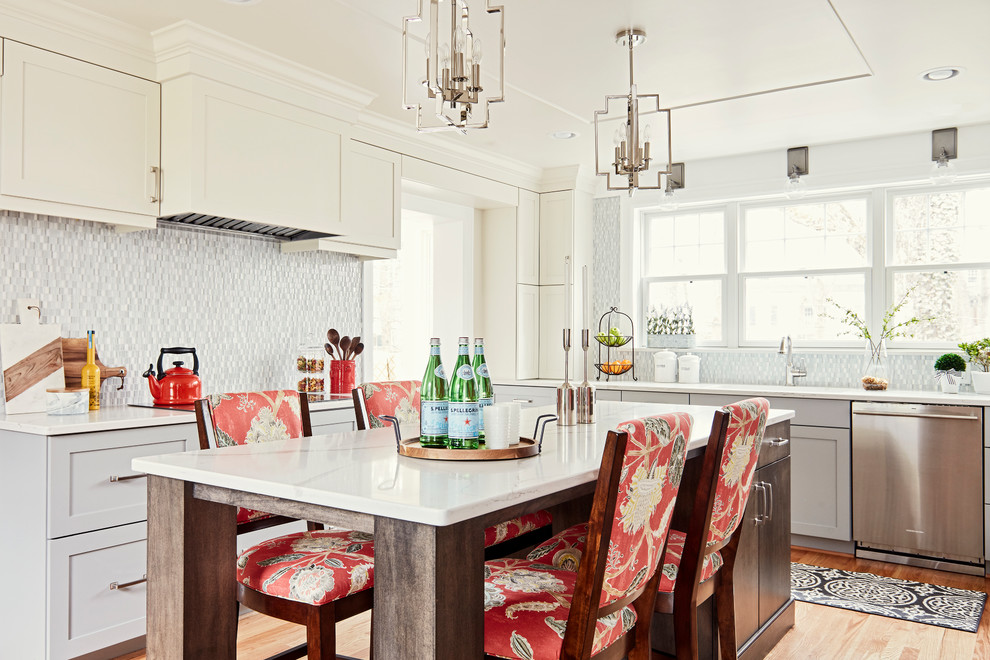 Inspiration for a mid-sized transitional u-shaped medium tone wood floor and brown floor enclosed kitchen remodel with an undermount sink, shaker cabinets, gray cabinets, quartz countertops, multicolored backsplash, glass sheet backsplash, stainless steel appliances, an island and white countertops