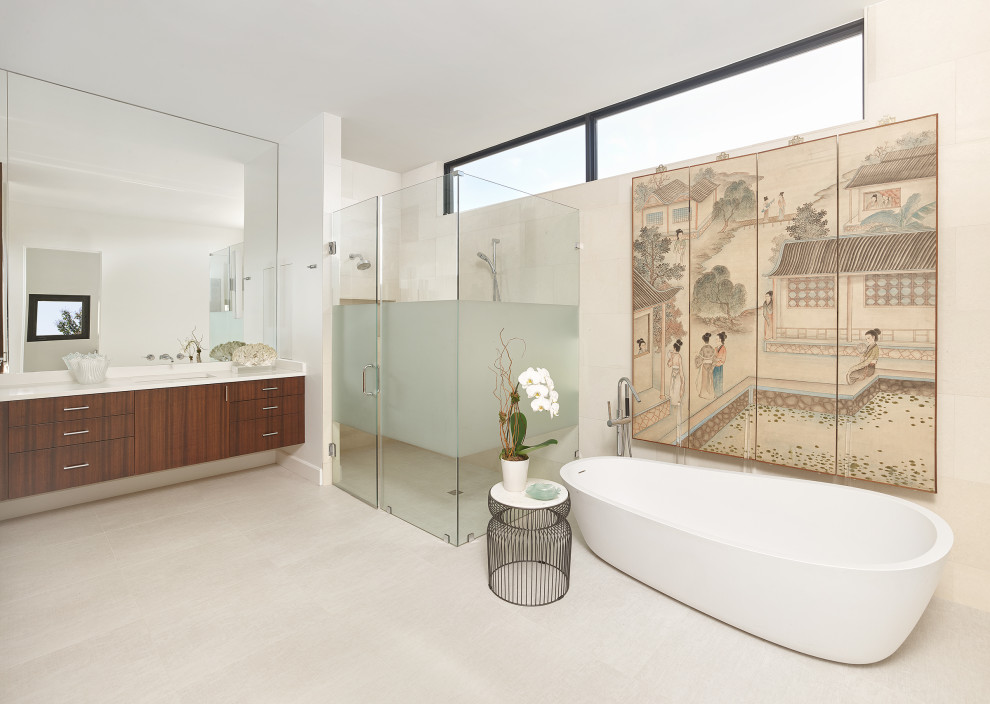 North Dallas - Inspiration for a mid-sized contemporary master beige tile and stone tile porcelain tile, beige floor and double-sink freestanding bathtub remodel in Dallas with flat-panel cabinets, brown cabinets, a one-piece toilet, white walls, an undermount sink, quartzite countertops, a hinged shower door, white countertops and a floating vanity