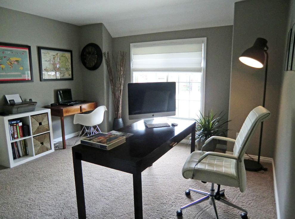 Inspiration for a large modern home office in London with grey walls, carpet, no fireplace and a freestanding desk.