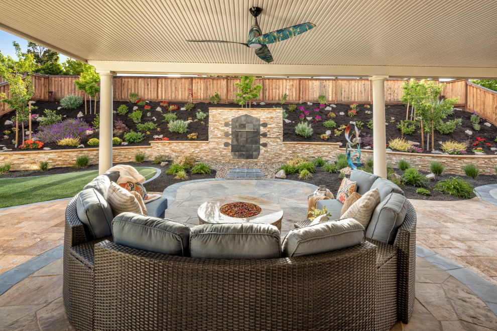 Design ideas for a large bohemian back patio in San Francisco with an outdoor kitchen, natural stone paving and a roof extension.
