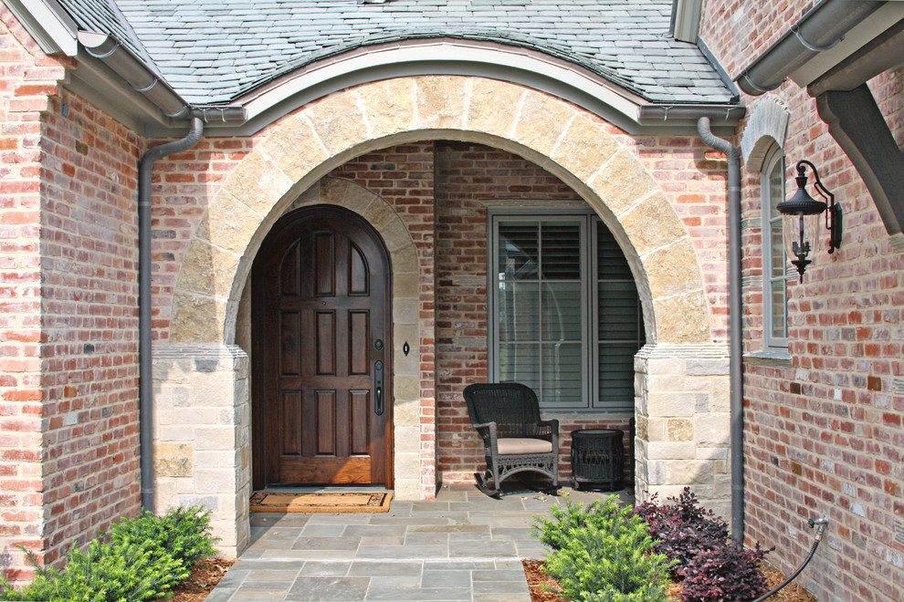 This is an example of a mid-sized traditional front door in Dallas with a single front door and a dark wood front door.