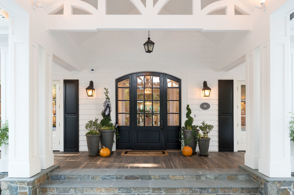 Country front door in San Francisco with white walls, medium hardwood floors, a single front door and a black front door.