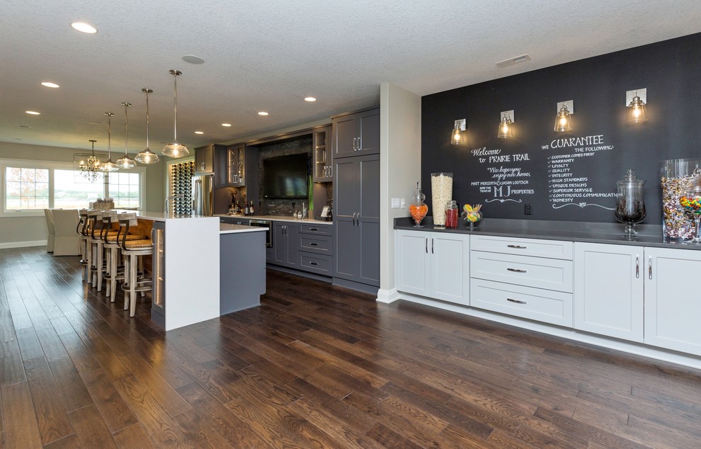 Eat-in kitchen - mid-sized transitional l-shaped dark wood floor eat-in kitchen idea with shaker cabinets, gray cabinets, an island, solid surface countertops, gray backsplash, stone tile backsplash and stainless steel appliances