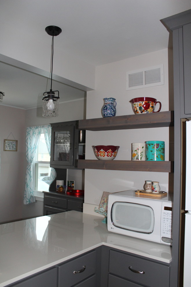Example of a small transitional u-shaped vinyl floor and brown floor eat-in kitchen design in Milwaukee with an undermount sink, flat-panel cabinets, gray cabinets, quartz countertops, white backsplash, an island and white countertops
