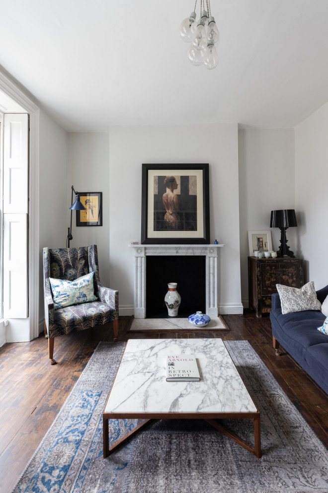 Medium sized living room in London with white walls, dark hardwood flooring, no tv and a chimney breast.