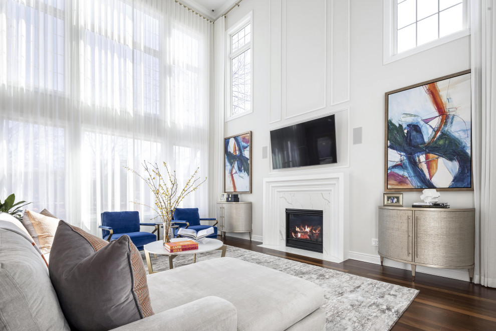 Photo of an expansive traditional open concept family room in New York with white walls, medium hardwood floors, a standard fireplace, a stone fireplace surround, a wall-mounted tv, brown floor, coffered and decorative wall panelling.