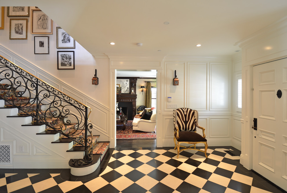 Traditional foyer in Los Angeles with white walls, a single front door, a white front door and multi-coloured floor.
