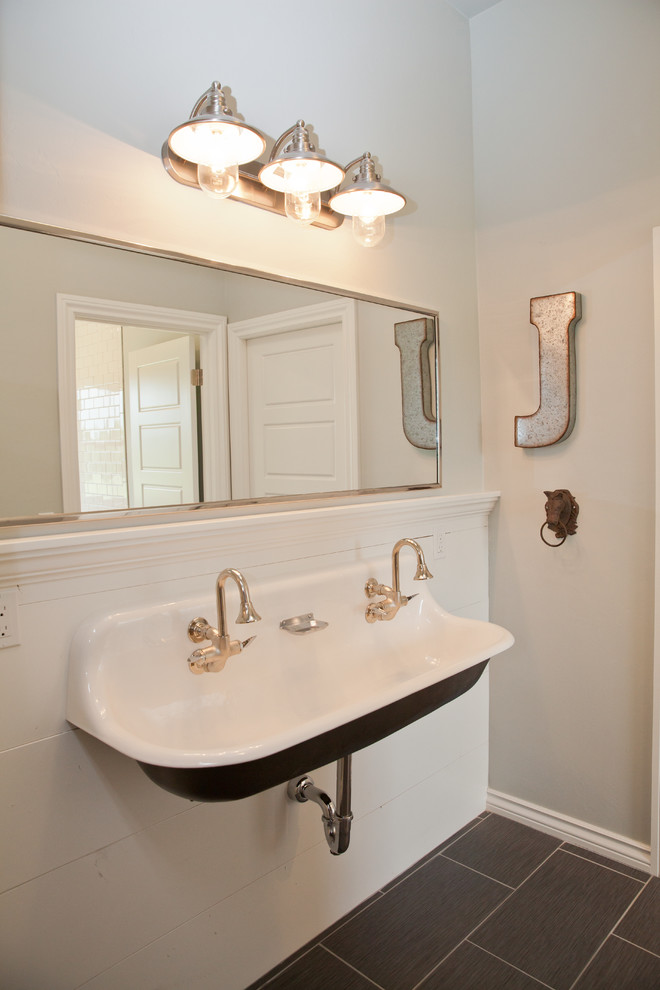 This is an example of a mid-sized country 3/4 bathroom in Oklahoma City with white tile, subway tile, beige walls, laminate floors, a wall-mount sink, black floor, an open shower, an alcove tub and a shower/bathtub combo.