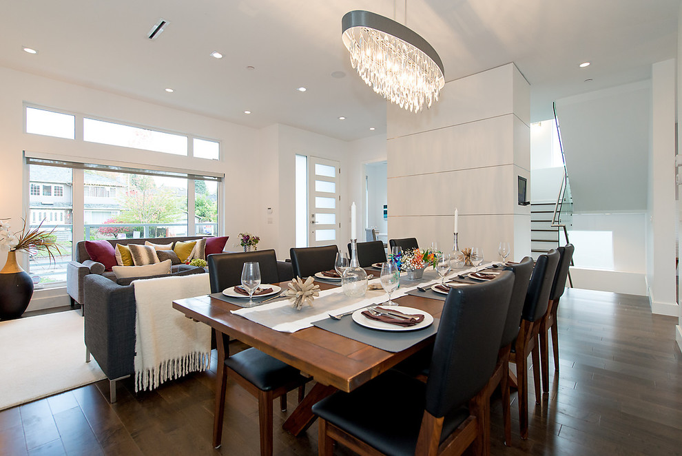 This is an example of a mid-sized transitional open plan dining in Vancouver with white walls, dark hardwood floors, no fireplace and brown floor.