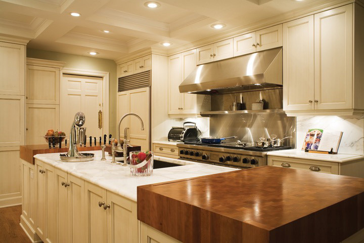 Example of a mid-sized transitional u-shaped kitchen design in Toronto with recessed-panel cabinets, white cabinets and an island