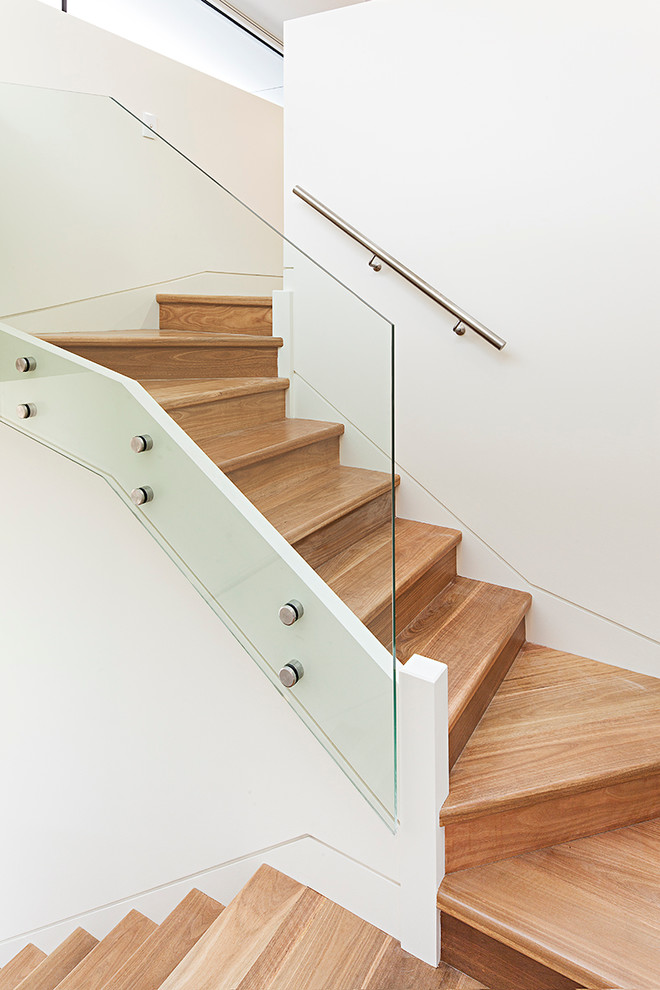 Photo of a beach style wood curved staircase in Sydney with wood risers.