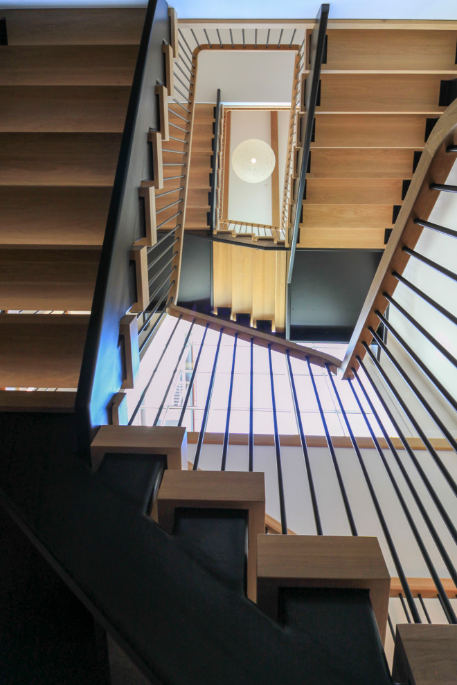 Inspiration for an expansive modern wood floating mixed railing staircase in DC Metro with tongue and groove walls.