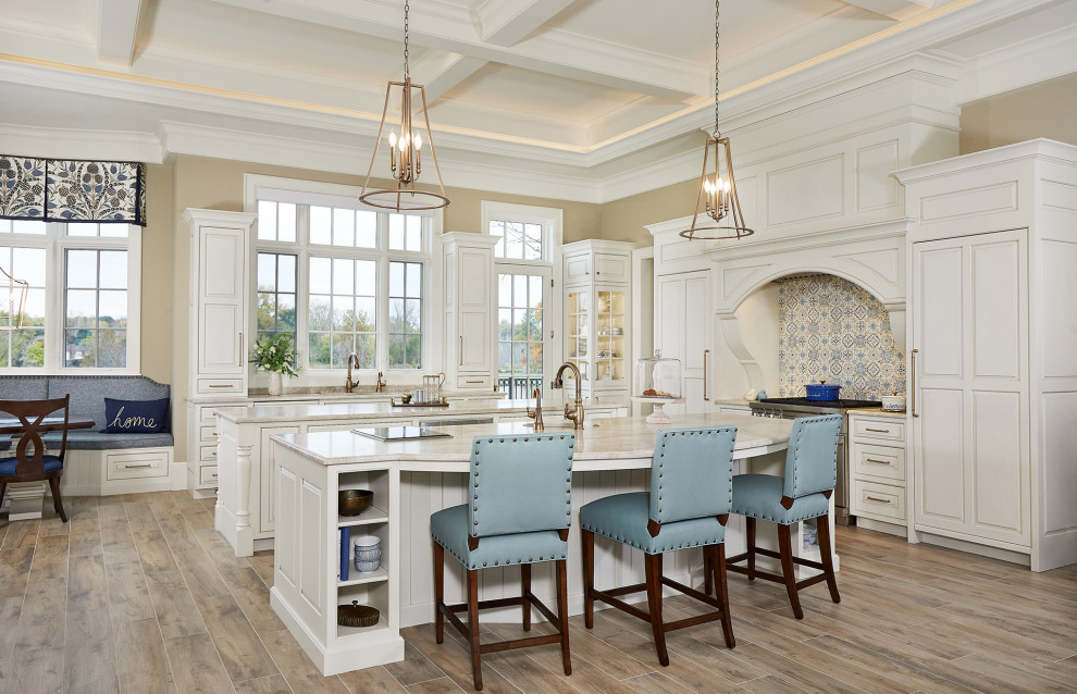 Inspiration for a l-shaped open plan kitchen in Grand Rapids with a submerged sink, beaded cabinets, white cabinets, engineered stone countertops, beige splashback, light hardwood flooring, multiple islands, beige floors, beige worktops, ceramic splashback, a coffered ceiling and feature lighting.