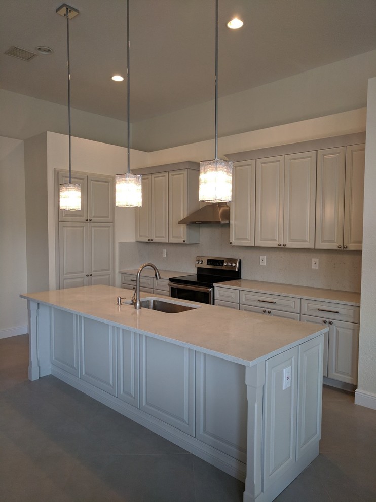 Inspiration for a mid-sized transitional u-shaped porcelain tile and gray floor eat-in kitchen remodel in Miami with an undermount sink, shaker cabinets, beige cabinets, quartz countertops, white backsplash, stone slab backsplash, stainless steel appliances, an island and white countertops