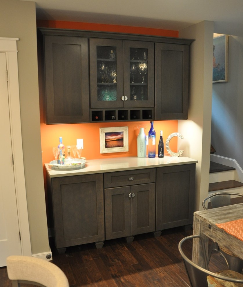 Example of a small transitional l-shaped dark wood floor and brown floor eat-in kitchen design in Boston with an undermount sink, recessed-panel cabinets, white cabinets, quartz countertops, white backsplash, porcelain backsplash, stainless steel appliances, an island and gray countertops