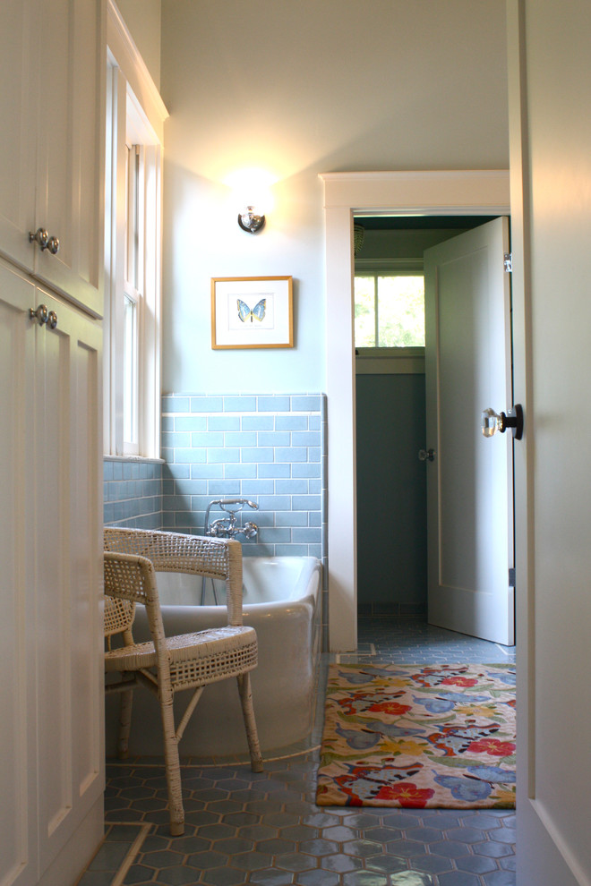 This is an example of a traditional bathroom in San Francisco with a freestanding tub and blue floor.