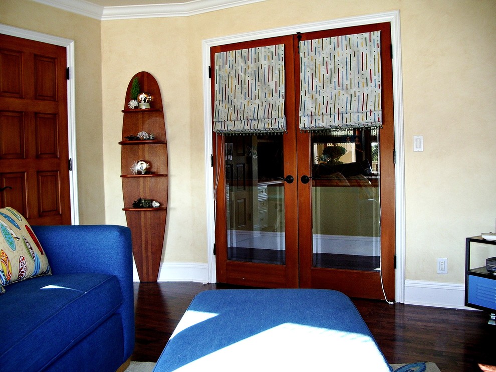 Photo of a small beach style gender-neutral kids' room in Orange County with beige walls and dark hardwood floors.