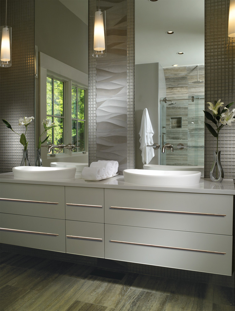 Inspiration for a mid-sized contemporary master bathroom in Charleston with a drop-in sink, white cabinets, gray tile, grey walls, vinyl floors, flat-panel cabinets, a corner shower, mosaic tile and solid surface benchtops.