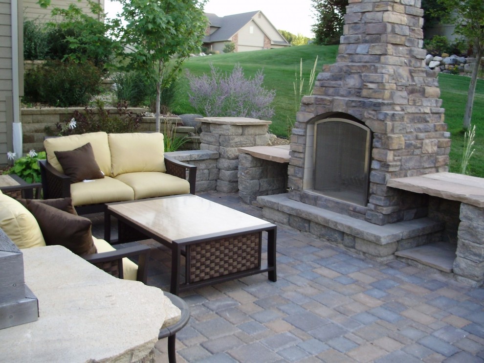 Inspiration for a mid-sized transitional backyard concrete paver patio remodel with a fire pit and no cover