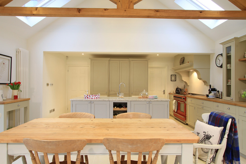 Design ideas for a large traditional l-shaped eat-in kitchen in Hampshire with a farmhouse sink, shaker cabinets, grey cabinets, granite benchtops, ceramic splashback, coloured appliances, porcelain floors and with island.