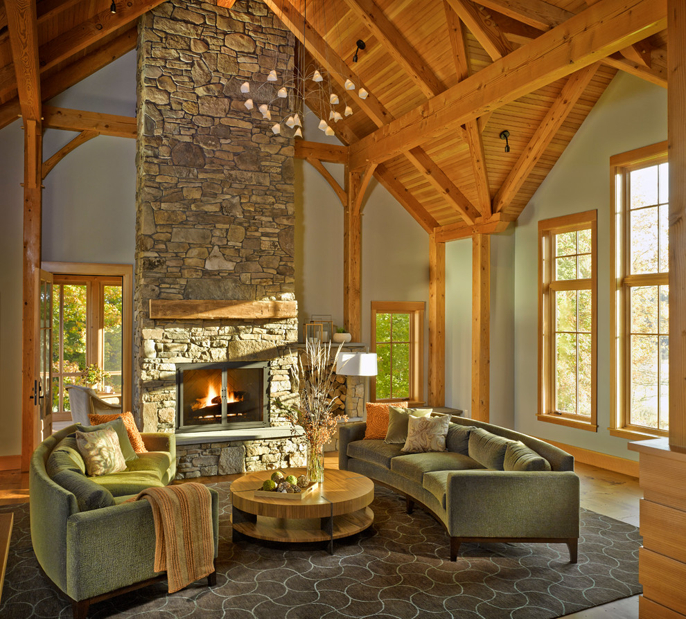 Design ideas for a country living room in Burlington with grey walls and a stone fireplace surround.