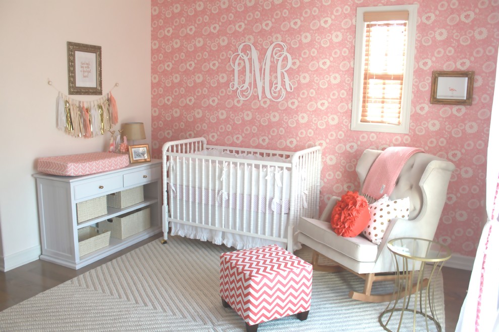 Inspiration for a mid-sized traditional nursery for girls in Orange County with pink walls and carpet.