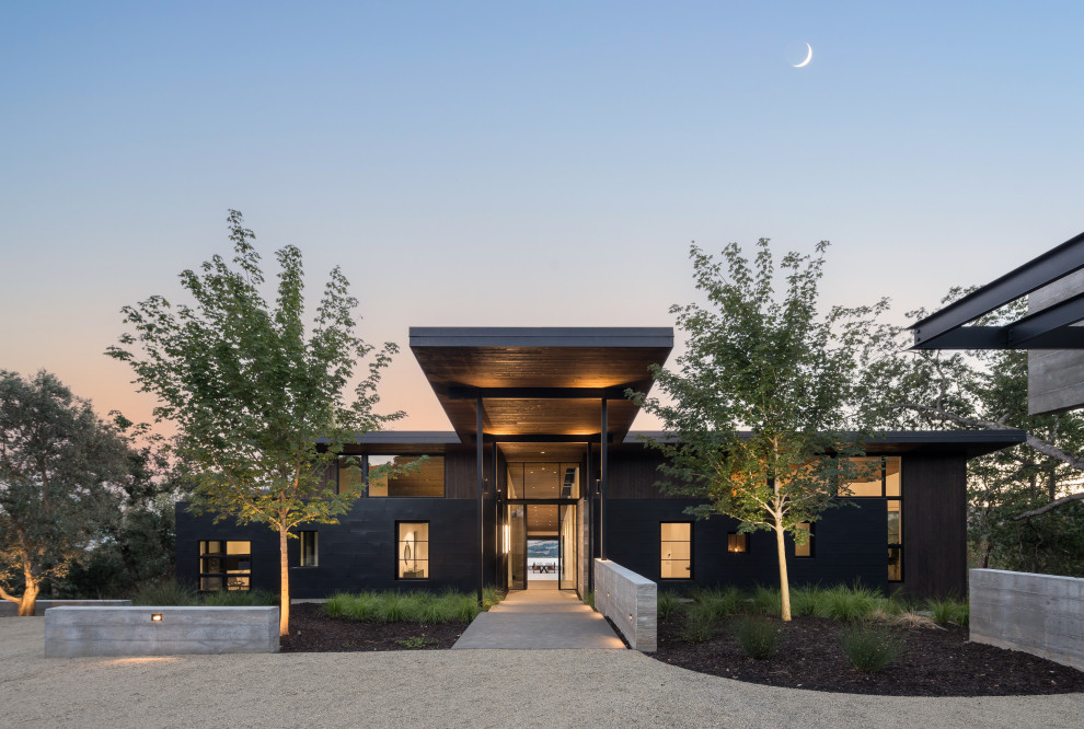 Inspiration for a large contemporary black one-story metal flat roof remodel