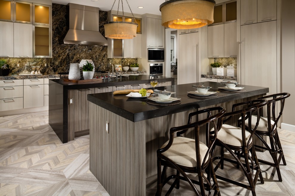 This is an example of a transitional kitchen in Philadelphia with flat-panel cabinets, light wood cabinets, multi-coloured splashback, stainless steel appliances and multiple islands.