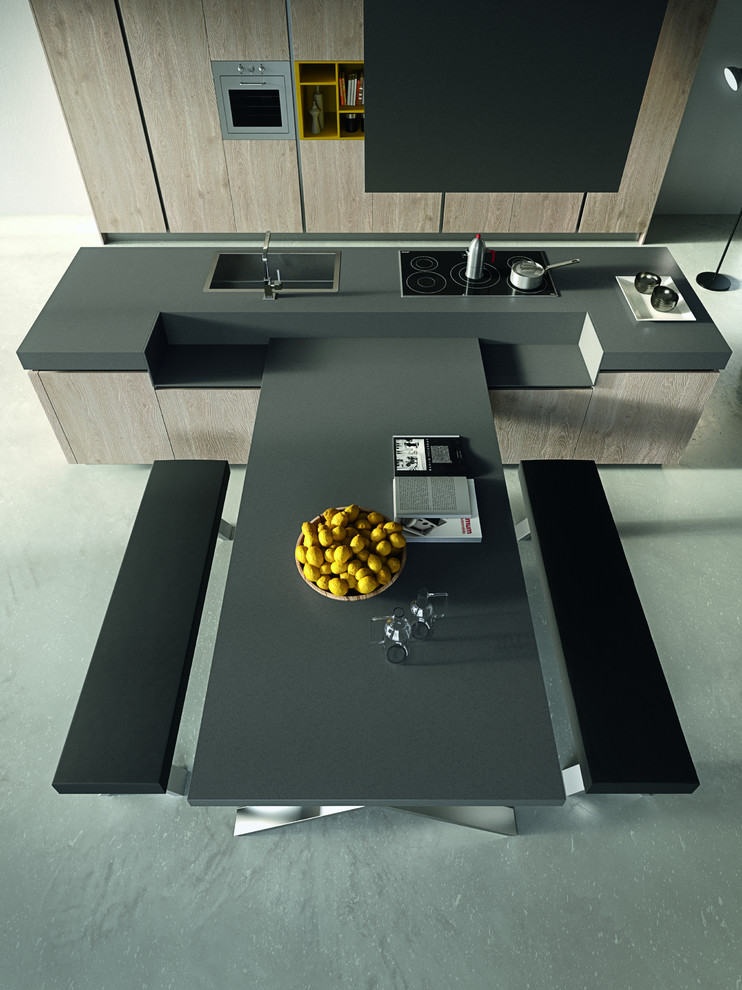 Inspiration for a mid-sized modern galley eat-in kitchen in Vancouver with a single-bowl sink, flat-panel cabinets, light wood cabinets, solid surface benchtops, stainless steel appliances, concrete floors, with island and grey floor.