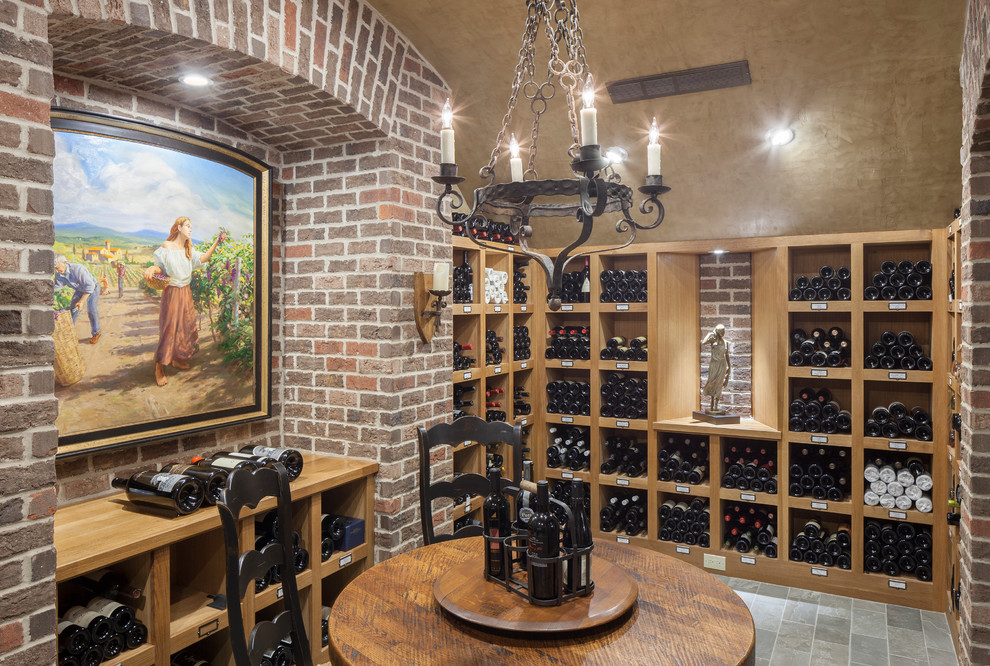 Inspiration for a timeless ceramic tile and gray floor wine cellar remodel in Grand Rapids with storage racks
