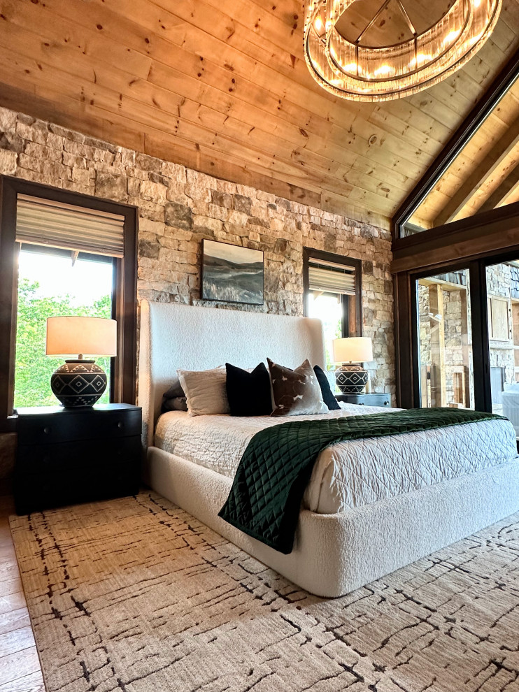 Mountain style master light wood floor and vaulted ceiling bedroom photo