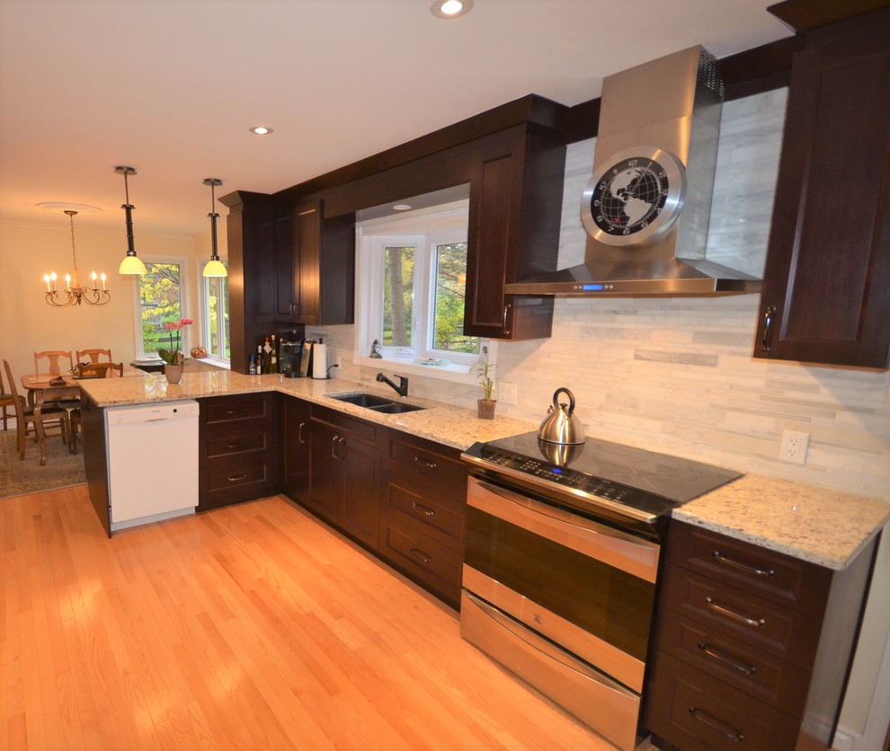 Example of a mid-sized transitional galley medium tone wood floor and brown floor eat-in kitchen design in Ottawa with a double-bowl sink, recessed-panel cabinets, dark wood cabinets, granite countertops, gray backsplash, porcelain backsplash, stainless steel appliances, a peninsula and beige countertops