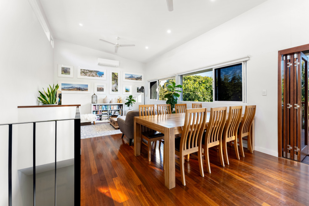 Photo of a large contemporary dining room in Brisbane with white walls and light hardwood floors.