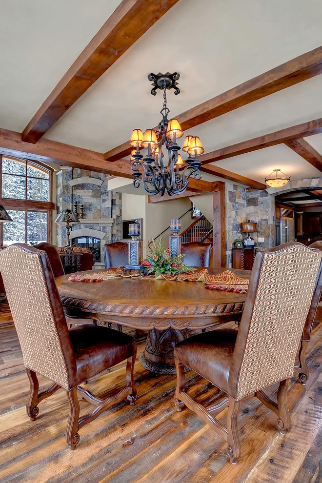 Country dining room in Denver with beige walls and dark hardwood floors.