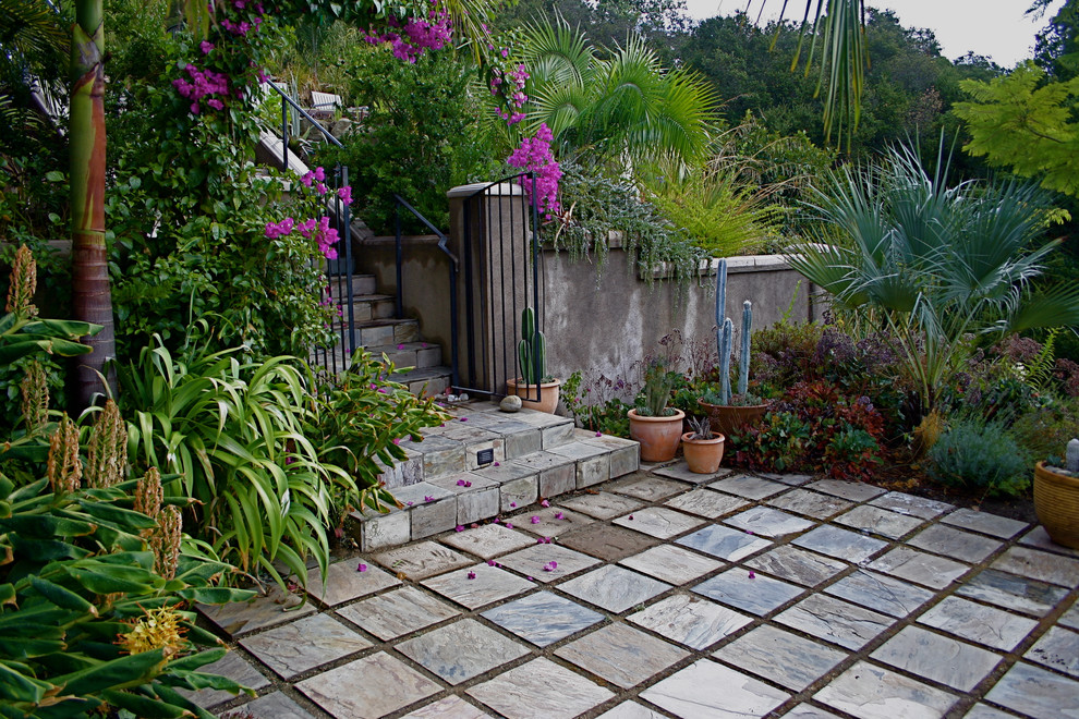 Design ideas for an eclectic sloped garden in San Francisco with natural stone pavers.