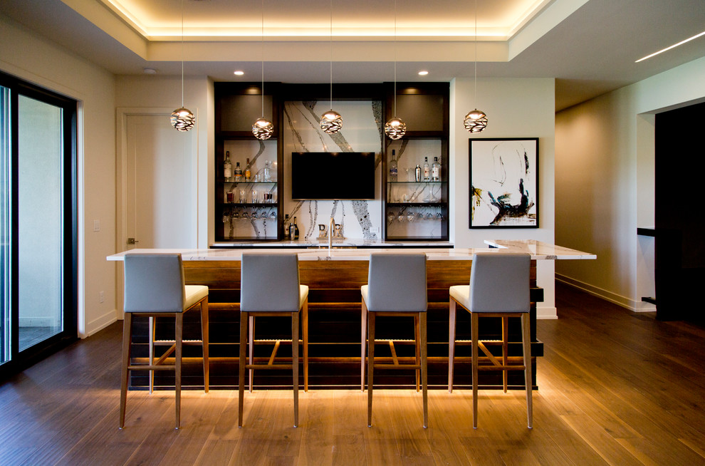 This is an example of a large contemporary l-shaped seated home bar in Kansas City with open cabinets, black cabinets, multi-coloured splashback, medium hardwood floors, brown floor, multi-coloured benchtop, an undermount sink, granite benchtops and stone slab splashback.