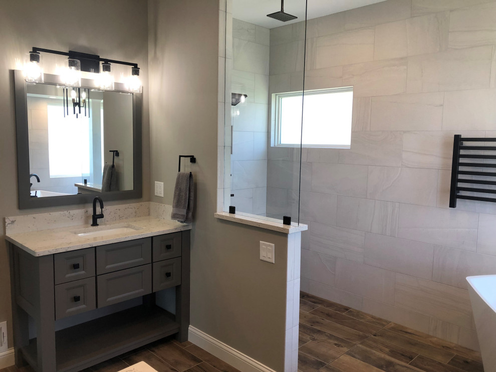This is an example of a modern master bathroom in Other with shaker cabinets, grey cabinets, an open shower, gray tile, grey walls, ceramic floors, an undermount sink, brown floor, an open shower and white benchtops.