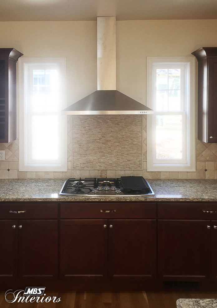 Inspiration for a large transitional medium tone wood floor eat-in kitchen remodel in Cincinnati with an undermount sink, recessed-panel cabinets, dark wood cabinets, quartz countertops, beige backsplash, stone tile backsplash, stainless steel appliances and an island