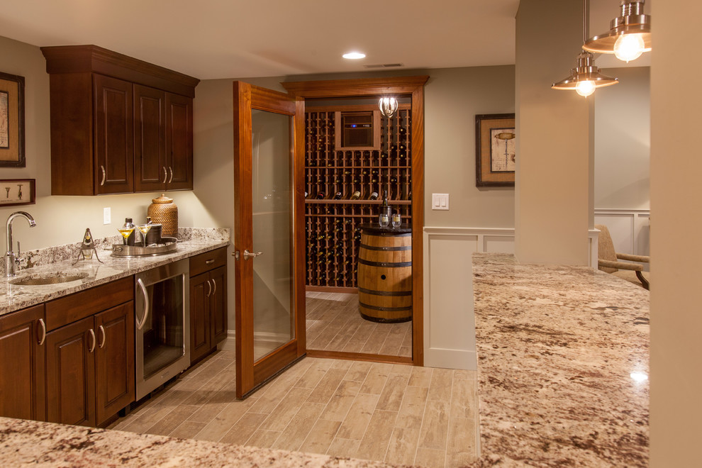 Photo of a mid-sized contemporary wine cellar in St Louis with light hardwood floors and storage racks.