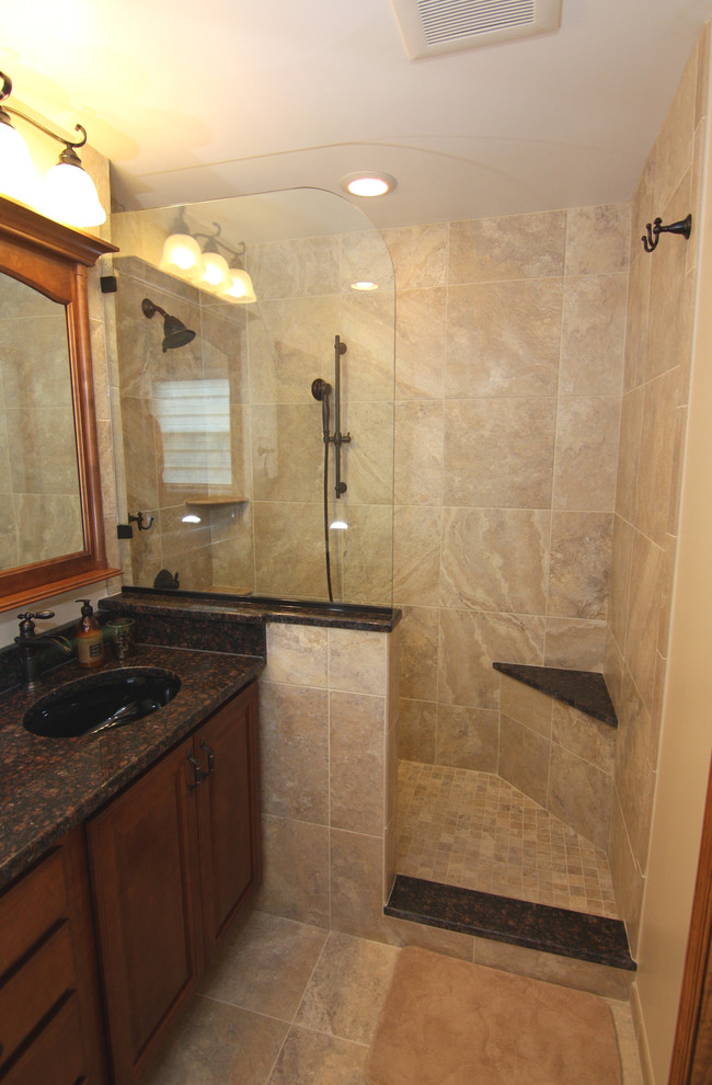 Photo of a small midcentury master bathroom in Philadelphia with an undermount sink, raised-panel cabinets, dark wood cabinets, granite benchtops, an open shower, a two-piece toilet, beige tile, porcelain tile, beige walls and porcelain floors.