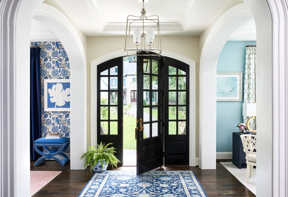 Example of a mid-sized trendy dark wood floor entryway design in Tampa with a glass front door
