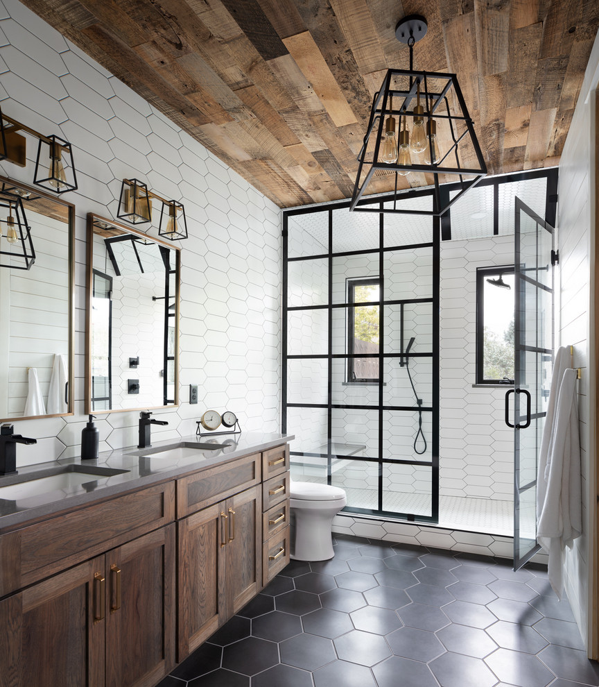 Design ideas for a transitional 3/4 bathroom in Denver with shaker cabinets, medium wood cabinets, an alcove shower, white tile, an undermount sink, black floor, a hinged shower door and grey benchtops.