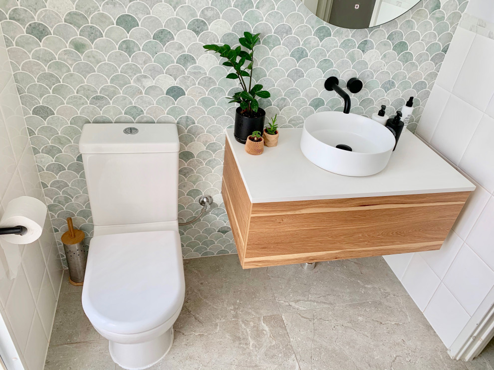Inspiration for a small midcentury bathroom in Perth with furniture-like cabinets, medium wood cabinets, a two-piece toilet, green tile, marble, green walls, cement tiles, a vessel sink, engineered quartz benchtops, grey floor, white benchtops, a single vanity and a floating vanity.