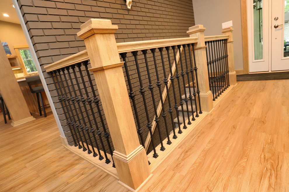 Example of a mid-sized transitional light wood floor and brown floor front door design in Grand Rapids with gray walls and a white front door