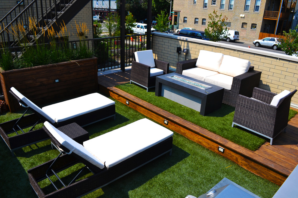 Example of a mid-sized trendy rooftop deck design in Chicago with a fire pit and no cover