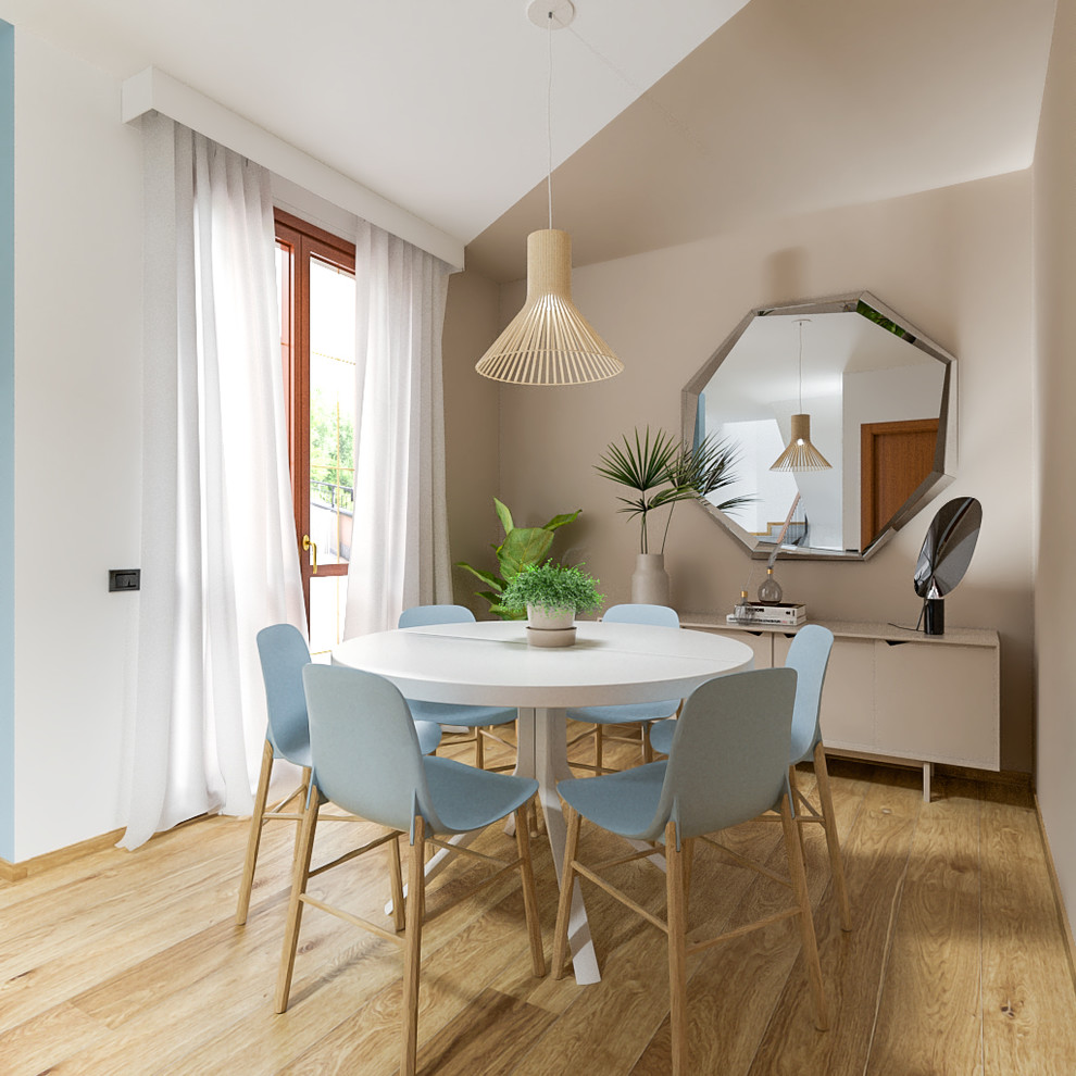 This is an example of a mid-sized contemporary open plan dining in Milan with beige walls and light hardwood floors.