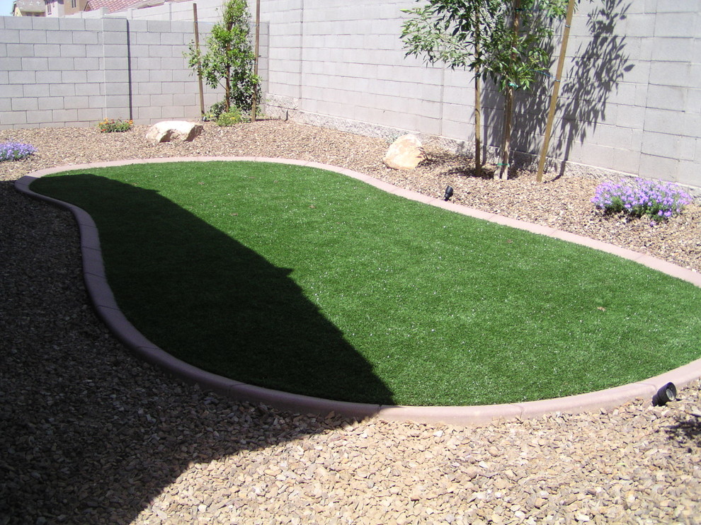 Photo of a small traditional backyard partial sun outdoor sport court in Phoenix with gravel.
