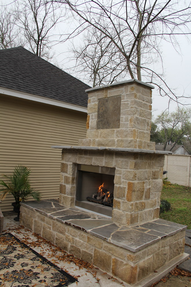 Inspiration for a large country backyard patio in Houston with a fire feature and concrete slab.
