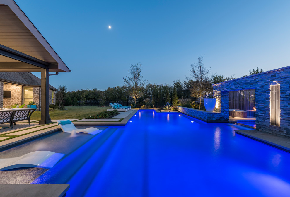 Design ideas for a large modern backyard custom-shaped pool in Dallas with a water feature.