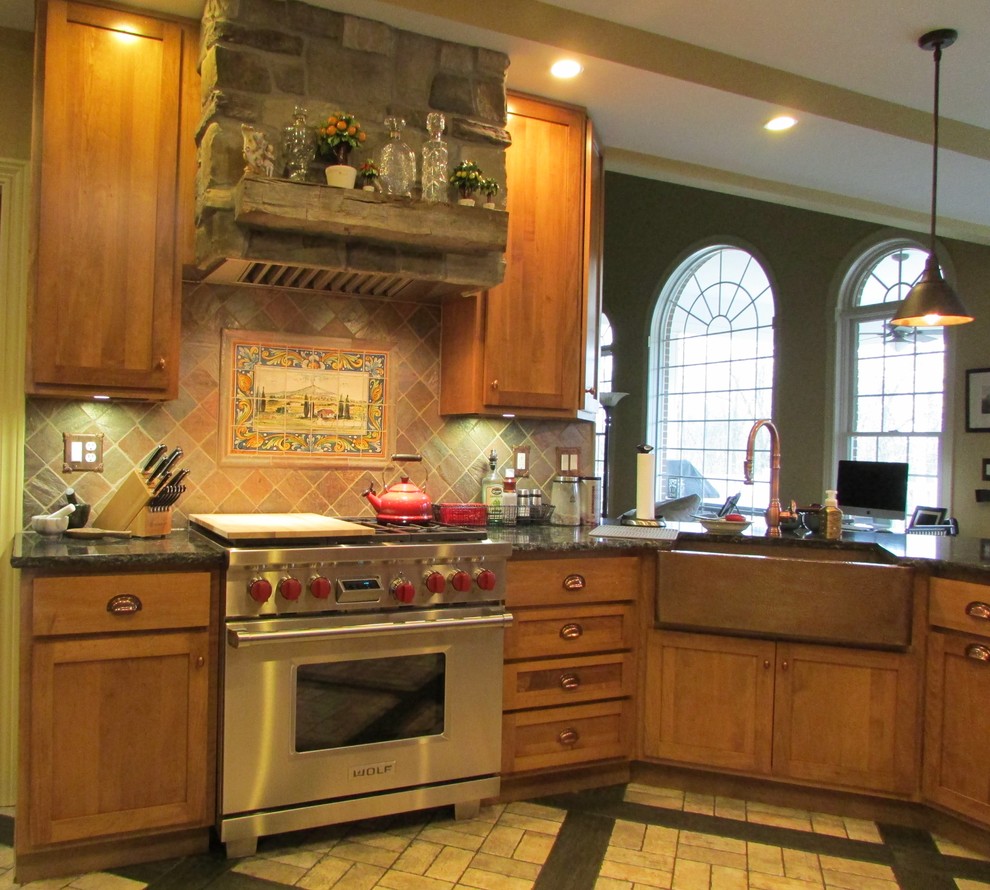 This is an example of a mid-sized traditional galley eat-in kitchen in Indianapolis with a farmhouse sink, shaker cabinets, medium wood cabinets, quartz benchtops, beige splashback, stone tile splashback, panelled appliances, brick floors and a peninsula.